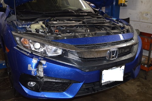 Honda civic bumper and quarter panel damage before repair at an auto body shop in toronto